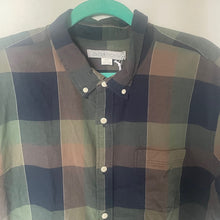 Load image into Gallery viewer, Plaid shirt on a hanger with a plain background