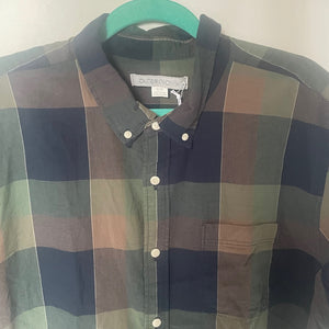 Plaid shirt on a hanger with a plain background