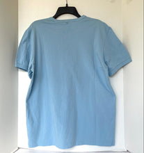 Load image into Gallery viewer, Light blue t-shirt on a hanger against a white background