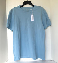 Load image into Gallery viewer, Light blue t-shirt on a hanger against a white background