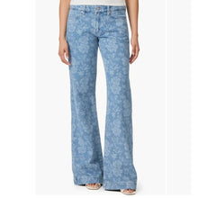 Load image into Gallery viewer, Light blue floral jeans worn by a person on a white background