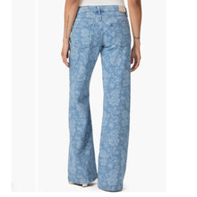 Load image into Gallery viewer, Light blue floral-patterned jeans worn by a person on a white background