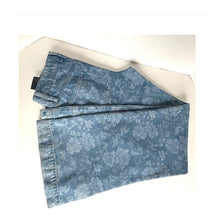 Load image into Gallery viewer, Folded blue floral jeans on a white surface