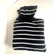 Load image into Gallery viewer, Folded black and white striped sweater on a white surface