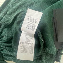 Load image into Gallery viewer, Clothing tag on a green fabric background