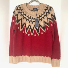 Load image into Gallery viewer, Red and beige patterned sweater on a hanger with a visible tag.