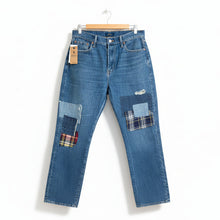Load image into Gallery viewer, Blue jeans with plaid patches on a white background