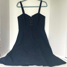 Load image into Gallery viewer, Navy blue dress on a hanger against a white background