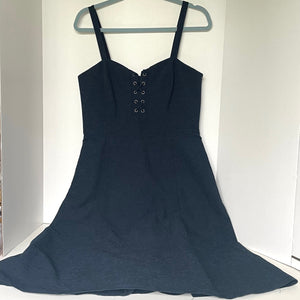 Navy blue dress on a hanger against a white background