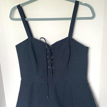 Load image into Gallery viewer, Blue dress with lace-up front on a hanger against a white background