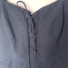 Load image into Gallery viewer, Textured gray garment with lace-up front on a neutral background