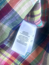 Load image into Gallery viewer, Multicolored plaid fabric with a white label on top