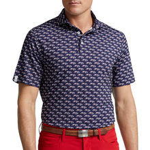 Load image into Gallery viewer, Man wearing a navy blue patterned polo shirt and red pants on a white background