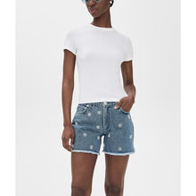 Load image into Gallery viewer, Person wearing a white t-shirt and blue denim shorts with floral embroidery on a white background