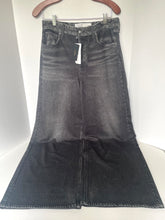 Load image into Gallery viewer, A dark gray washed denim flare skirt hanging from a wooden hanger against a white background.