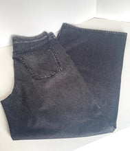Load image into Gallery viewer, A pair of folded dark gray washed denim jeans, showing the back pocket and waistband, laid flat on a white surface.