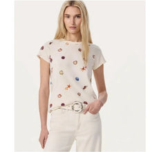 Load image into Gallery viewer, Woman wearing a cream-colored t-shirt with colorful patterns on a white background