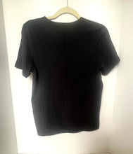 Load image into Gallery viewer, Black t-shirt on a hanger against a white background