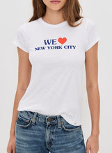 Load image into Gallery viewer, A woman wearing a white short-sleeve crewneck t-shirt with a blue and red graphic that reads 'WE [heart] NEW YORK CITY', paired with blue jeans, against a light gray background.