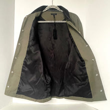 Load image into Gallery viewer, Green and black jacket on a hanger against a white background