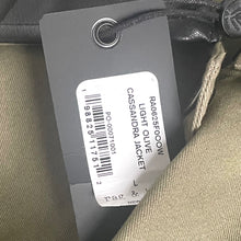 Load image into Gallery viewer, Clothing tag on a jacket with product details.
