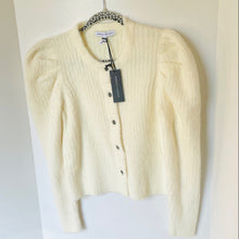 Load image into Gallery viewer, Cream-colored cardigan on a hanger with a visible tag against a white background