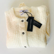 Load image into Gallery viewer, Folded cream-colored garment with tags on a light gray background