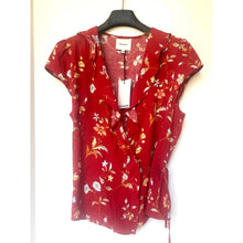 Load image into Gallery viewer, Red floral blouse on a hanger against a white background