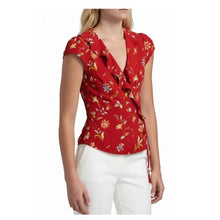 Load image into Gallery viewer, Woman wearing a red floral blouse with white pants on a white background