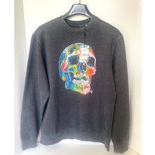 Load image into Gallery viewer, Gray sweatshirt with a colorful skull design on a hanger against a white background