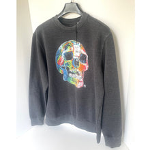 Load image into Gallery viewer, Gray sweatshirt with a colorful skull design on a hanger against a white background