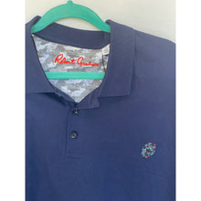 Load image into Gallery viewer, Blue polo shirt with a patterned collar on a hanger