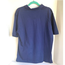 Load image into Gallery viewer, Blue shirt on a hanger against a white wall