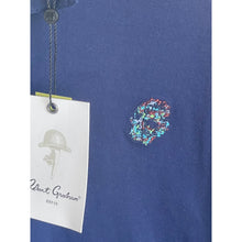 Load image into Gallery viewer, Blue polo shirt with a colorful logo and Robert Graham tag.