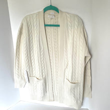Load image into Gallery viewer, Beige cable knit cardigan on a hanger against a white background