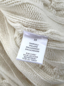 Close-up of a label on a textured beige fabric with text.
