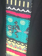 Load image into Gallery viewer, A close-up of a black garment featuring a vertical panel with a colorful African-inspired geometric and tribal pattern in turquoise, pink, yellow, black, and white.