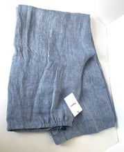 Load image into Gallery viewer, Folded blue pants with a tag on a white background