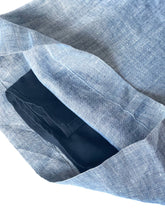 Load image into Gallery viewer, Blue denim fabric with a pocket showing a black interior