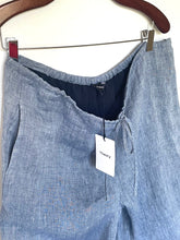 Load image into Gallery viewer, Blue pants on a hanger with a 'Theory' tag.