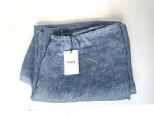 Load image into Gallery viewer, Folded blue pants with a tag on a white background