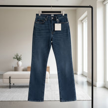 Load image into Gallery viewer, Pair of blue jeans with a tag on a white background