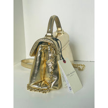 Load image into Gallery viewer, Gold metallic handbag with a tag on a white background