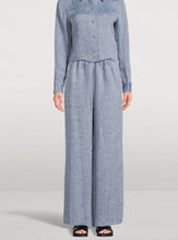 Load image into Gallery viewer, Person wearing a blue checkered outfit on a light gray background