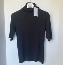 Load image into Gallery viewer, Black turtleneck shirt on a hanger with a white background