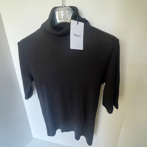 Black turtleneck sweater on a hanger with 'Theory' tag against a white background