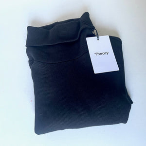 Folded black garment with a 'Theory' tag on a white background