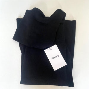 Folded black sweater with a 'Theory' tag on a white background
