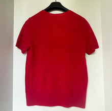Load image into Gallery viewer, Red t-shirt on a hanger against a white background