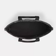 Load image into Gallery viewer, Black oval-shaped product with handles on a white background